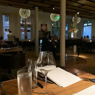 a table with a glass of water and a menu