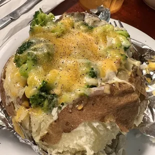 a baked potato with broccoli and cheese