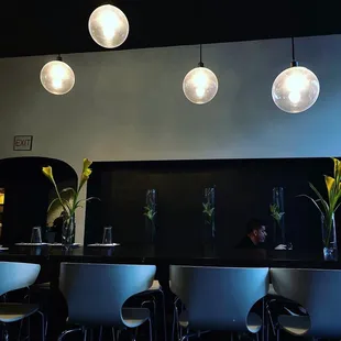 a row of chairs at a bar