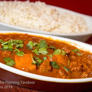 Beef Vindaloo Tender piece of beef and potato cooked with hot madras spices.