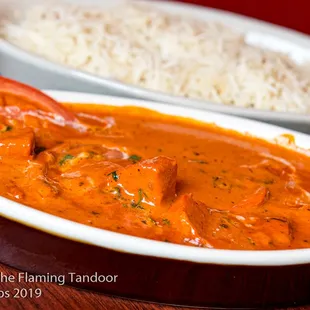 Butter Chicken Boneless pieces of chicken tikka cooked with sorted seasonal vegetables cooked in a rich gravy.
