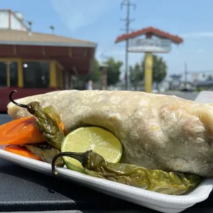 Surf and turf burrito comes with rice fries guacamole carne asada and shrimp.