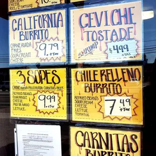 a window with a variety of signs