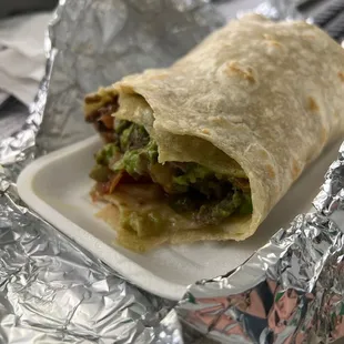 a burrito wrapped in aluminum foil