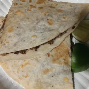 two quesadillas on a paper plate
