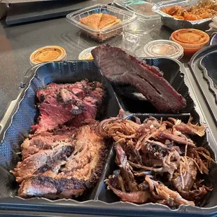 Four meat platter with pulled lamb shoulder, beef rib, beef brisket, and pastrami. Wonderful food.