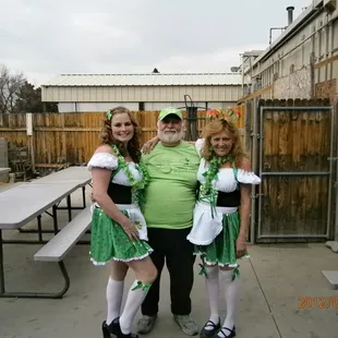 a man and two women dressed in irish costumes