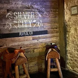 two saddles and a sign