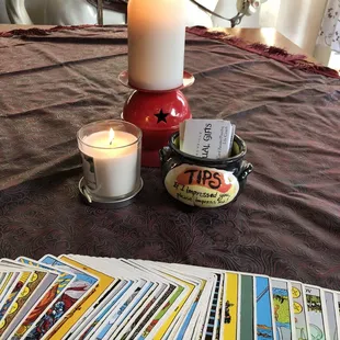 a candle and a deck of tarot cards