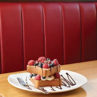 a waffle with berries and whipped cream