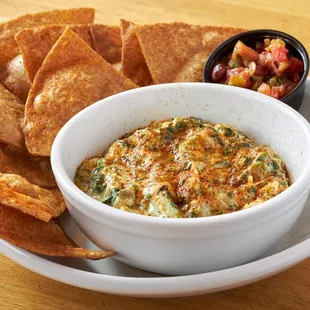 a bowl of dip and chips