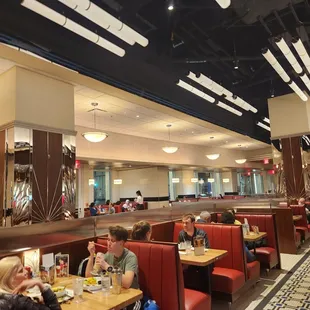 people sitting at tables in a restaurant