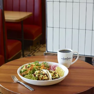 a bowl of salad and a cup of coffee