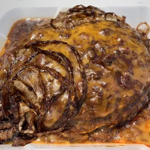 Chili pancakes - corn cakes w/ hearty chili, cheddar cheese, and grilled onions. A must-try showstopper. You&apos;ll be full till dinner.
