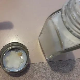 Salt stuck to top of salt shaker covering the holes. This had to be like this for a while for this to happen.