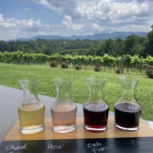 four glasses of wine and a pitcher
