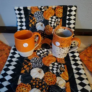 two mugs on a quilted placemat