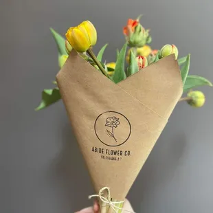 a person holding a bouquet of flowers