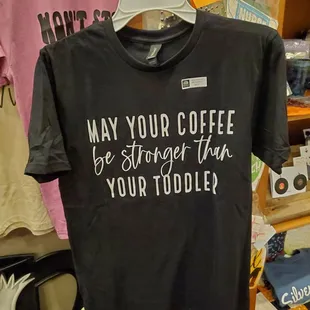 a t - shirt that says may your coffee be stronger than your toddler