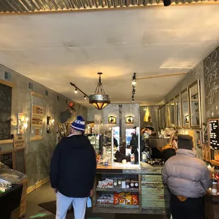 two people standing in a coffee shop