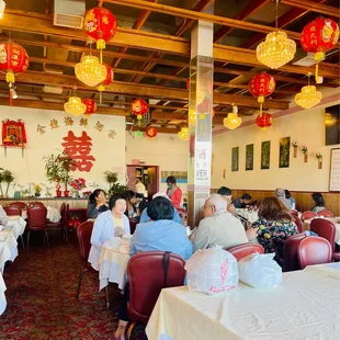 people sitting at tables in a restaurant