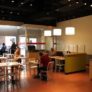 people in a restaurant with tables and chairs