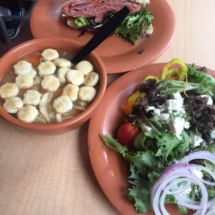Chicken noodle soup, Greek salad and muffaletta