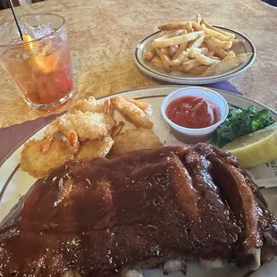 Ribs, deep fried butterfly shrimp, and fries. I had the cheesy broccoli soup, too. All very tasty!