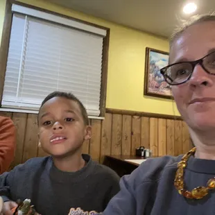 a woman and a boy sitting at a table