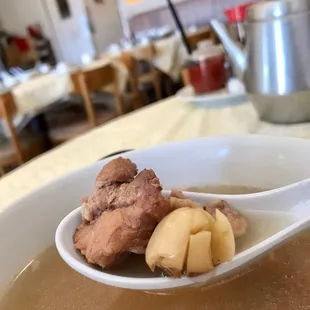 a bowl of soup and a spoon of food