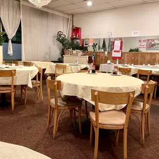 tables and chairs with white tablecloths