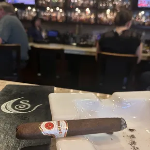 a cigar on a white plate