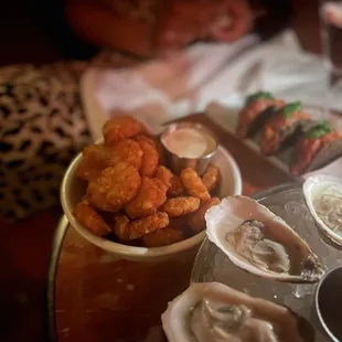 a table with oysters and other foods