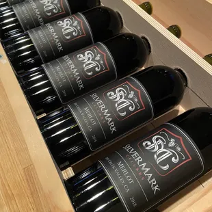six bottles of wine in a wooden case