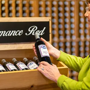 a woman opening a bottle of wine