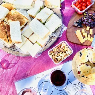 a table of sandwiches and wine