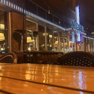 Handsome tables and chairs on a broad sidewalk.