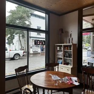 a table and chairs in front of a large window
