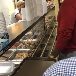 a man in a red shirt and a woman in a blue and white checkered shirt