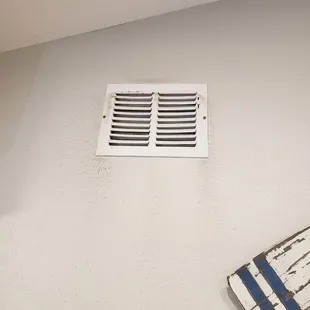cold air return in kitchen caked with dust and grime even on the walls