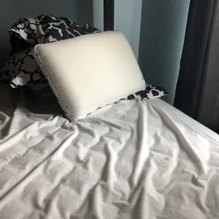 Lovely unmade bed with stains. (Bed upon arrival)