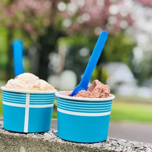 two cups of ice cream on a ledge