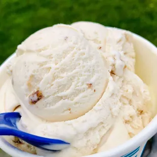 a hand holding a cup of ice cream