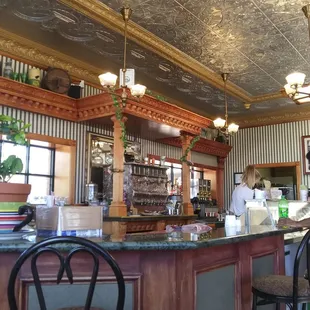 a man standing at a counter in a restaurant