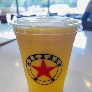 a yellow drink with a red star on it