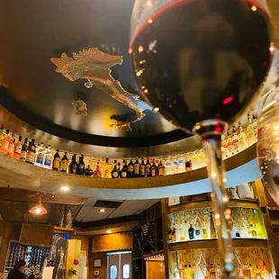 a glass of wine on a bar