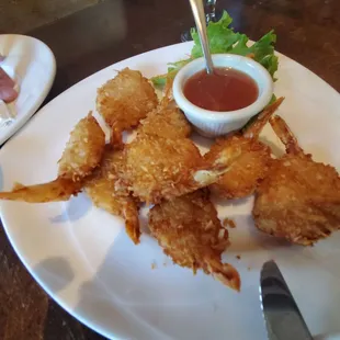 Coconut shrimp paired with papaya salad. Dipped in curry sauce.. yummy.