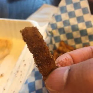 a hand holding a piece of food