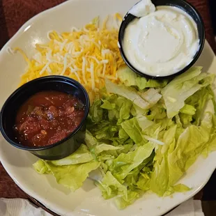 Shredded lettuce, salsa, sour cream, and Cheddar Jack cheese