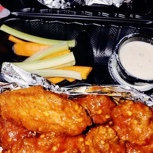 Hot jet lag wings with a side of potato wedges